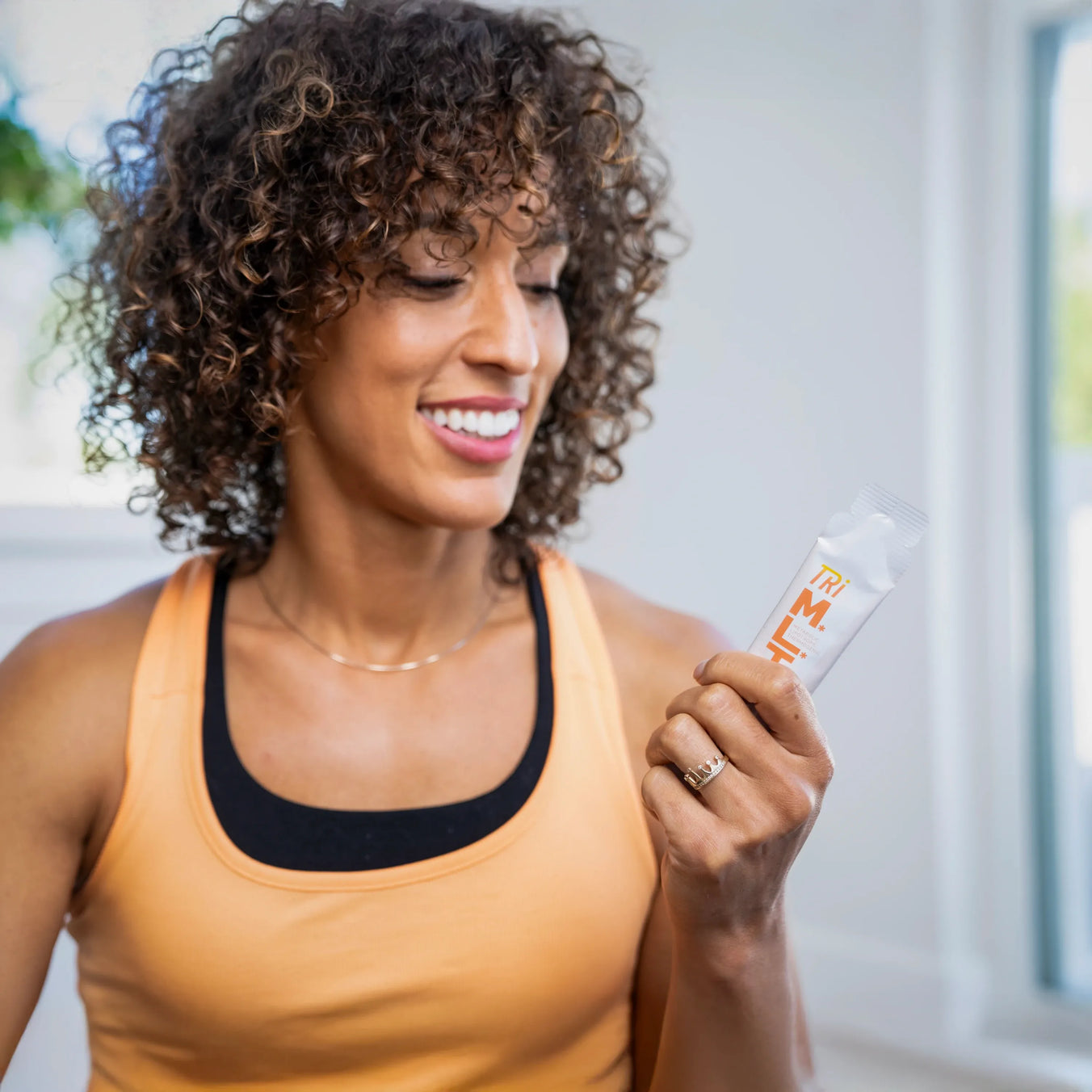 tri-mlt_woman_holding_sachet.webp